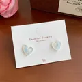 Blue marble heart stud earrings with silver frame on a white display card - Pearly Blue Heart (YRH3)