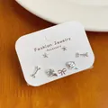 Three-pair silver stud earring set with star bone and puppy designs on display card - Dog Bone Three-Pair Set (HXT15)