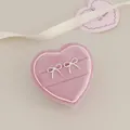 Silver bow stud earrings in a heart-shaped jewelry box with romantic ribbons - Polished Bowknot