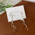 Blue and pink gradient butterfly tassel earrings on a display card for elegant style - Pink and Green Butterfly Tassel (HDT21)