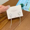 Star-shaped earrings with colorful opal-style finish and silver chain tassels - Iridescent Double Tassel Star Style