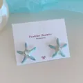Orecchini a forma di stella marina blu con cristallo a cuore e design marino - Stella Marina Zirconia Blu Bianco