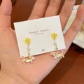 Handheld view of cute polka dot dachshund puppy drop earrings with yellow flower charms - Yellow Flower Dachshund Drop Style
