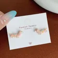 Cute pink dachshund earrings with white pearl collar and blue bow on display card - Brown Pearl Dachshund Drop Style