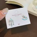 Asymmetric carousel and rocking horse earrings with blue enamel and pearls on cards - Blue Merry-go-round (MMW19)