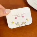 Cartoon carousel horse and rainbow charm stud earrings set displayed on card - Rainbow Unicorn (KTT027)