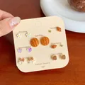 7-day tortoiseshell leopard print studs set featuring bear and bread motifs on beige card - Pineapple Bun