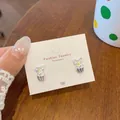 Cupcake-Ohrringe mit transparenter Schleife und bunten Streuseln auf Schmuckkarte - Eiscreme Zirkon Stil