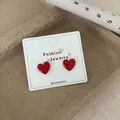 Elegant cherry red heart stud earrings with glossy finish on display card - Large Red Heart Stud (REW3)