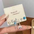 Bohemian silver earring set featuring blue gems, rose, elephant, and cross pendants - Elephant Wings Style (YYT2)