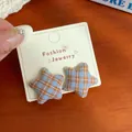 Star-shaped plaid earrings in light blue and brown fabric on jewelry card - Blue Yellow Plaid Star