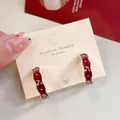 Retro cherry red wave hoop earrings with silver accents on a jewelry display card - Red Cherry C-Shaped Hoop (LF22)