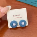 Blue denim fabric button earrings with white heart center on jewelry card - Denim Blue Fabric Heart