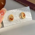 Vintage amber resin oval stud earrings with beige matte border in a warm aesthetic - Oval Meillard Studs