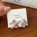 Vintage brown and white plaid star-shaped fabric stud earrings on jewelry card - Brown White Plaid Star