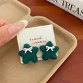 Dark green plush star earrings with silver bow details on a white display card - Green Bow Star
