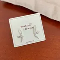 Minimalist silver bow earrings with fluid lines on white display card for women - Line Bow