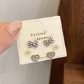 Three-piece brown panda-themed stud earrings set featuring heart and flower designs - Polka Dot Heart Bow (QDT1)