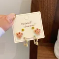 Three-piece set of cartoon bear and yellow rhinestone earrings on a white display card - Bear with Strawberry Hat (QDT3)