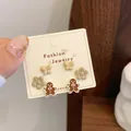 Three-pair stud earring set with brown butterfly, flower, and gingerbread man designs - Flower Gingerbread Man (QDT4)