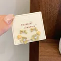 Three-piece set of cream yellow bow, heart, and flower stud earrings with pearls - Pearl Three-Petal Flower (QDT7)