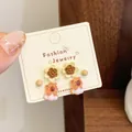Three-piece earring set with cartoon bear, floral, and bead studs on display card - Flower Capybara (QDT11)
