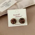 Elegant leopard print flocked round stud earrings with soft texture on display card - Leopard Semi-round
