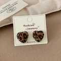 Leopard print heart-shaped flocked earrings with silver needles on display card - Leopard Print Heart