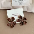 Elegant leopard print flower earrings with a soft flocked texture on a jewelry card - Dahlia Flower Leopard Flocked