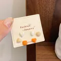Set of 6 cute minimalist geometric stud earrings in orange and beige on jewelry card - Maillard Geometric (DJ1)