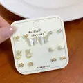 6-pair set of minimalist golden earrings with butterfly, floral and zircon designs on a card - Gold Rabbit Butterfly