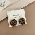 Furry leopard print round stud earrings with autumn winter aesthetic on jewelry card - Leopard Round