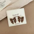 Leopard print flocked bow earrings for women on a decorative jewelry display card - Leopard Bow