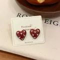 Retro heart stud earrings in deep brown-red finish on jewelry display card - Heart Stud Earrings / Red