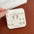 Golden stud earring set featuring floral, heart, and butterfly designs on display card - Coffee Morning Glory
