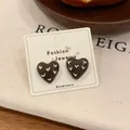 Vintage chocolate brown heart earrings with white V-pattern and gold-tone accents - Heart Stud Earrings / Brown