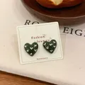 Retro dark green heart stud earrings with white heart patterns on display card - Heart Stud Earrings / Green