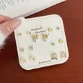 Exquisite gold ear stud set with butterfly, cat and pearl designs on a display card - Pearl Cat