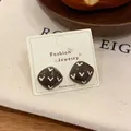 Brown vintage square heart stud earrings on jewelry card with cozy lifestyle background - Square Stud Earrings / Brown
