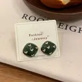 Retro dark green square stud earrings with cream heart pattern on display card - Square Stud Earrings / Green