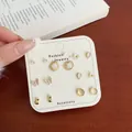 7-day gold stud earring set with flower and butterfly designs on a display card - Round Flower Butterfly