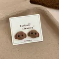 Cute brown flocked teddy bear stud earrings displayed on a white fashion jewelry card - Dumb Dog Head / Brown