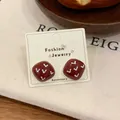 Retro dark red square stud earrings with white heart pattern on display card - Square Stud Earrings / Red
