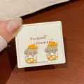 Cute grey puppy dog stud earrings in yellow polka dot cup shown on display card - Orange Pajama Dog (KTW43)