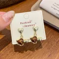 French vintage style amber heart earrings with gold trim on fashion display card - Double Heart Brown Bead Pendant (UJ10)