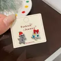 Christmas earring set featuring gingerbread man and tree icons on display card - Silver Christmas Tree Gingerbread Man