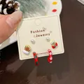 Christmas stud earring set featuring festive stockings, pearls, and red snowflake hoops - Striped Candy Gloves