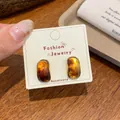 French vintage amber resin stud earrings with golden base on jewelry card - Oval Amber Studs (XC2)