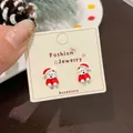Cartoon white bear Christmas stud earrings with red festive hats on a display card - Red Hat Bear Stud Earrings