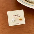 Cute orange cat and white fish stud earrings displayed on a fashion jewelry card - White Fish and Orange Cat (KTW52)